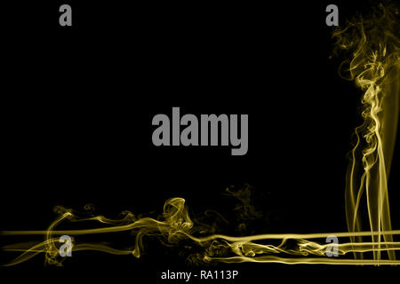 Abstract yellow colored smoke flowed on black background. . Abstract yellow color smog clouds. Stock Photo
