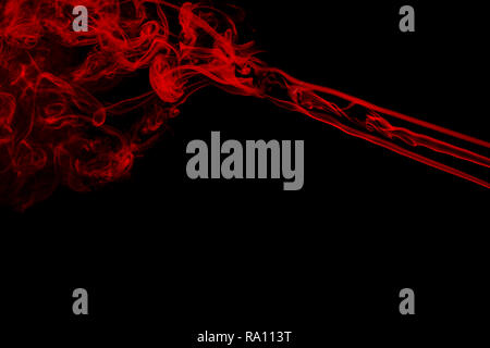 Movement of colorful smoke. Abstract red  smoke on black background. Dramatic red smoke clouds. Stock Photo