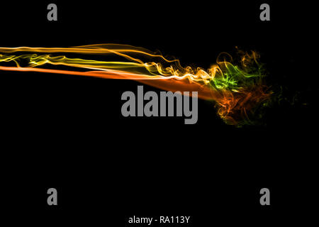 Abstract multi colored smoke flowed on black background. . Abstract yellow tone color smog clouds. Stock Photo