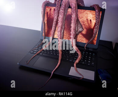Computer Lumps Computer virus concept. Laptop seized by disgusting monster with long ...