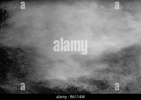 White talcume powder explosion on black background. White dust splashing. Stock Photo