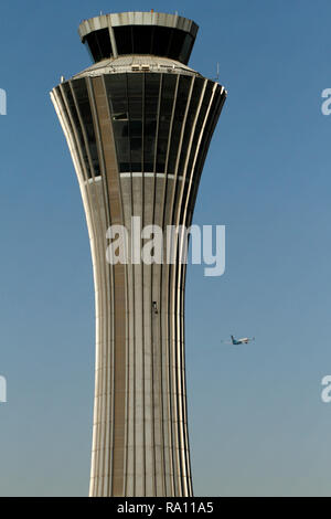 Flight taking off from Beijing Capital International Airport, China and passing the control tower at Terminal 3. Stock Photo