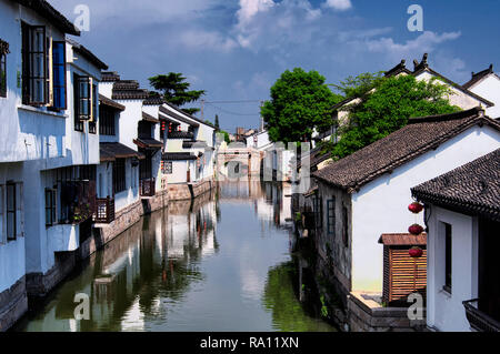 The white weathered buildings of the Luzhi Water Town scenic area in Wuzhong area of Suzhou China in Jiangsu Province on a sunny day. Stock Photo