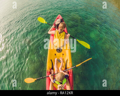 Mother and son kayaking at tropical ocean Stock Photo