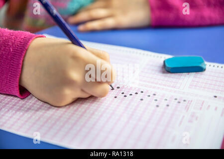 Pencil drawing selected choice on answer sheets. hand fill in Exam carbon paper computer sheet and pencil. Stock Photo