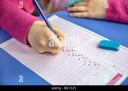 Pencil drawing selected choice on answer sheets. hand fill in Exam carbon paper computer sheet and pencil. Stock Photo