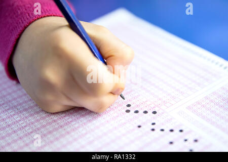 Pencil drawing selected choice on answer sheets. hand fill in Exam carbon paper computer sheet and pencil. Stock Photo