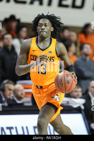 Stillwater Oklahoma USA. 29th December 2018. Oklahoma State Guard Isaac Likekele 13 dribbles the ball during a basketball game between the Texas A M University Corpus Christi Islanders and Oklahoma St...