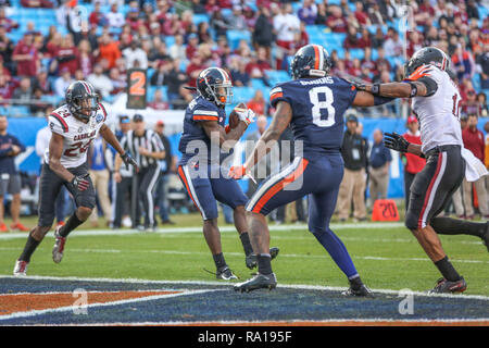 Charlotte, NC, USA. 29th Dec, 2018. Virginia Cavaliers wide receiver Olamide Zaccheaus (4) catches his third touchdowns of the day during NCAA football action between the South Carolina Gamecocks and the Virginia Cavilers at Bank of America Stadium in Charlotte, NC. Jonathan Huff/CSM/Alamy Live News Stock Photo