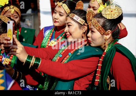 Kathmandu, Nepal. 30th Dec, 2018. Nepalese women from ethnic Gurung community in traditional attire take photos as they take part in parade to mark their New Year also known as Tamu Losar.The indigenous Gurungs, also known as Tamu, are celebrating the advent of the year of the deer. Credit: ZUMA Press, Inc./Alamy Live News Stock Photo