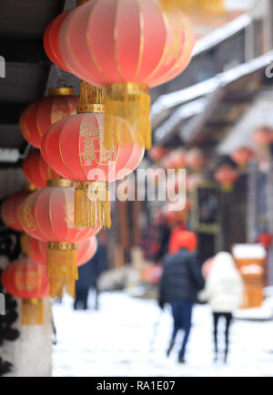 Qiandongnan, China's Guizhou Province. 30th Dec, 2018. Tourists roam on a snow-covered ancient street within Liping County seat in Qiandongnan Miao and Dong Autonomous Prefecture, southwest China's Guizhou Province, on Dec. 30, 2018. Credit: Yang Daifu/Xinhua/Alamy Live News Stock Photo