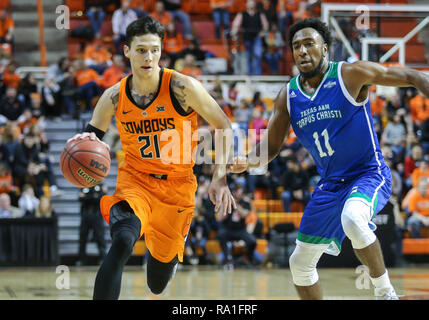 Stillwater, USA. 29th Dec, 2018. Oklahoma State Guard Lindy Waters, III (21) dribbles the ball during a basketball game between the Texas A&M University-Corpus Christi Islanders and Oklahoma State Cowboys at Gallagher-Iba Arena in Stillwater, OK. Gray Siegel/CSM/Alamy Live News