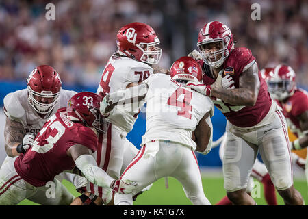 Florida, USA. 29th Dec, 2018. Oklahoma Sooners running back Trey Sermon (4) is brought down by Alabama Crimson Tide defensive lineman Raekwon Davis (99) for a loss of yards during the fourth quarter in the 2018 Capital One Orange Bowl at Hard Rock Stadium on December 29, 2018 in Florida. Credit: Travis Pendergrass/ZUMA Wire/Alamy Live News Stock Photo