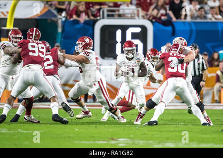 Florida, USA. 29th Dec, 2018. Oklahoma Sooners running back Trey Sermon (4) carries the ball for a short gain during the first quarter against the Alabama Crimson Tide in the 2018 Capital One Orange Bowl at Hard Rock Stadium on December 29, 2018 in Florida. Credit: Travis Pendergrass/ZUMA Wire/Alamy Live News Stock Photo