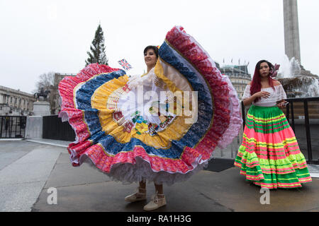 London, UK. 30 December 2018 Some of London New Year Day Parade’s performers kick-start festivities in front of the National Gallery, Trafalgar Square, London, UK. Members of the  Carnaval del Pueblo, pose for photos in Trafalgar Square after their performance. Credit: Carol Moir / Alamy Live News