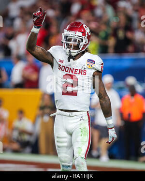 CeeDee Lamb Oklahoma Sooners Unsigned Crimson Jersey Throwing a Pass During  2018 College Football Playoff Semifinal Photograph