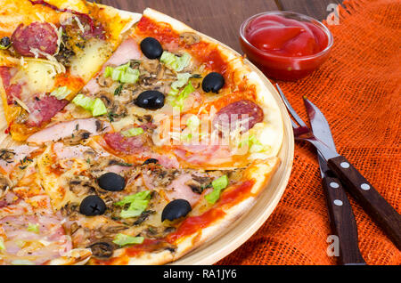 Six slices of pizza with different toppings on wooden board. Studio Photo Stock Photo