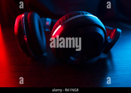 headphones on dark background in neon light Stock Photo