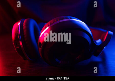 headphones on dark background in neon light Stock Photo