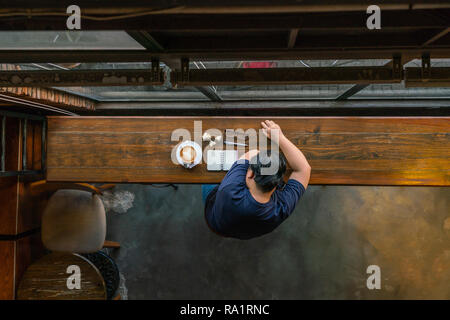 Top view of young Asian freelancer sleeping Stock Photo