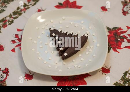 Christmas tree shaped chocolate cake with sugar stars Stock Photo