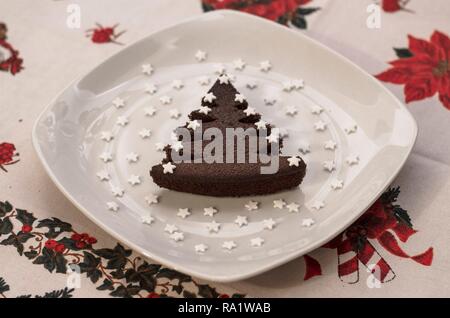 Christmas tree shaped chocolate cake with sugar stars Stock Photo