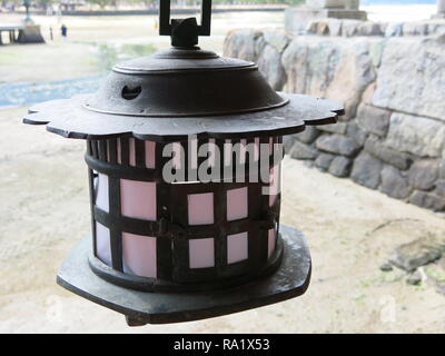 Itsukushima Shrine on Miyajima Island featuring a traditional Japanese lantern Stock Photo