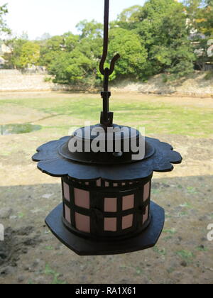 Itsukushima Shrine on Miyajima Island featuring a traditional Japanese lantern Stock Photo