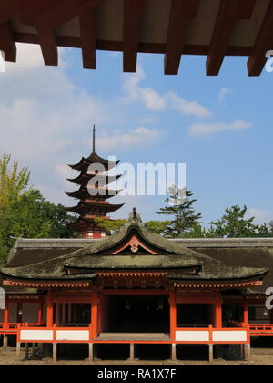 One of the many buildings built on stilts above the water, and connected by decking and boardwalks, that make up Itsukushima Shrine on Miyajima Island Stock Photo