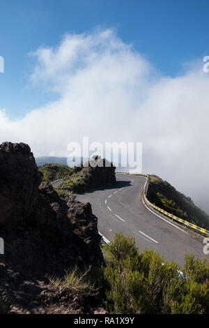 Hairpin bend on a rocky hillside with mist Stock Photo