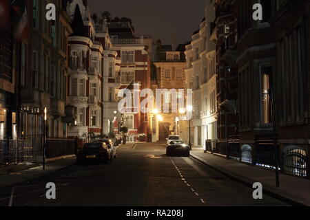 St. James Hotel and Club facade. Picture taken in London, Park Place at night. Few expensive cars park at this street.  Mayfair London Stock Photo
