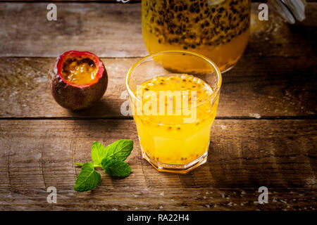 Glass of fresh passion fruit mint on table Stock Photo