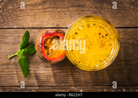 Glass of fresh passion fruit mint on table Stock Photo