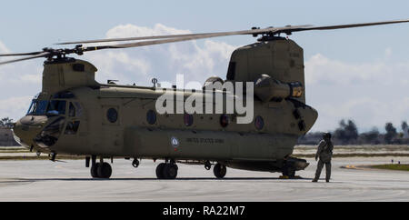 A California Army National Guard CH-47F Chinook flying in support of Company B, 1st Battalion, 126th Aviation Regiment, prepares for takeoff with a load of Army National Guard soldiers, Feb. 22, 2018, at Joint Forces Training Base, Los Alamitos, California. The soldiers, all members of the 5th Battalion, 19th Special Forces Group, came from companies in the California, Colorado, and Utah National Guards. They conducted several jumps during the week to train on a new parachute system. (U.S. Air National Guard photo by Senior Airman Crystal Housman) Stock Photo