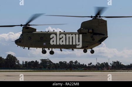 A California Army National Guard CH-47F Chinook flying in support of Company B, 1st Battalion, 126th Aviation Regiment, takes off with a load of Army National Guard soldiers, Feb. 22, 2018, at Joint Forces Training Base, Los Alamitos, California. The soldiers, all members of the 5th Battalion, 19th Special Forces Group, came from companies in the California, Colorado, and Utah National Guards. They conducted several jumps during the week to train on a new parachute system. (U.S. Air National Guard photo by Senior Airman Crystal Housman) Stock Photo