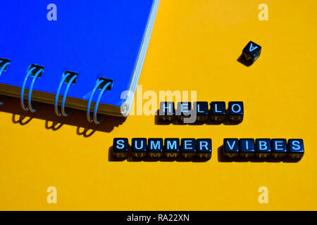 Hello summer vibes on wooden blocks. business concept on orange background Stock Photo