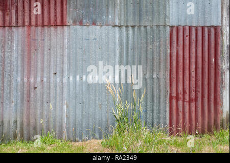 Colorful patterned corrugated iron wall Stock Photo