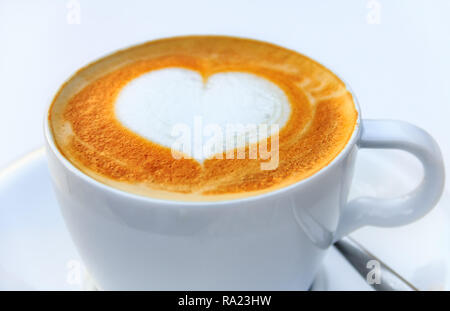 Close up on a cup of a hot coffee with a latte art heart design at a cafe in Palma de Mallorca in Mallorca in Spain Stock Photo