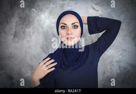 Beautiful young arab woman in traditional dress in the studio on gray background. Stock Photo