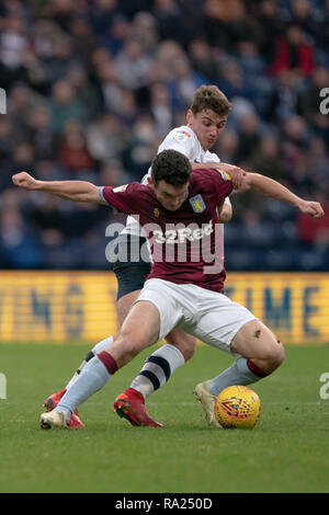 Aston Villa's John McGinn is tackled by Preston North End's Ryan Ledson  29th December 2018, Deepdale, Preston, England; Sky Bet Championship, Preston North End vs Aston Villa ;    Credit: Terry Donnelly/News Images  English Football League images are subject to DataCo Licence Stock Photo