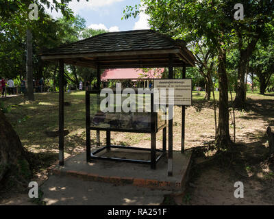 Display cabinet holding some of victims clothes revealed after rain storm in Choeung Ek Killing Fields victims of brutal Khmer Rouge outskirts Phnom P Stock Photo