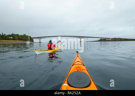 Sea kayaking on the Kyle of Lochalsh towards the bridge to the Isle of Skye, Scotland Stock Photo
