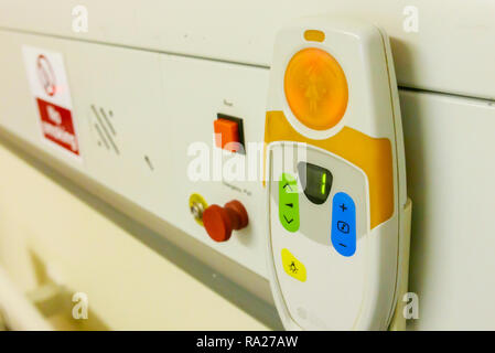 Bed head unit in a hospital ward showing an emergency red pull call bell and an electrostatic discharge point. Stock Photo