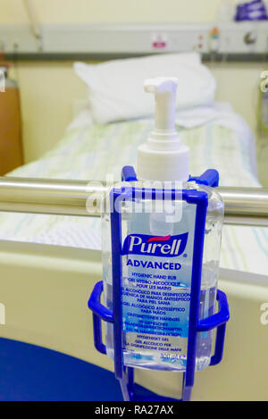 Bottle of Purell Advanced alcohol hygienic hand rub at the end of a hospital bed. Stock Photo