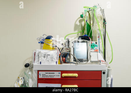 Hospital crash trolley for emergency resuscitation with a electrocardiograph ECG and a defibrillator along with emergency fluids etc. Stock Photo