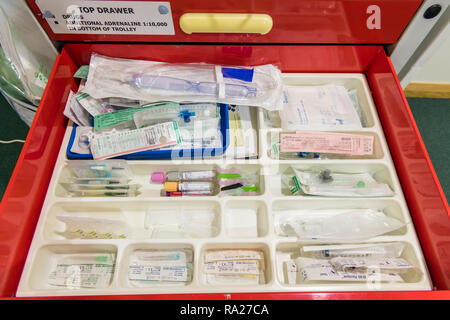 Drawer in a hospital crash trolley for emergency resuscitation containing hypodermic needles, syringes etc. Stock Photo