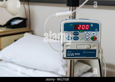 Drip infusion pump in a hospital ward, used to deliver controlled doses of fluids and medicines. Stock Photo