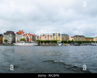 Panoramic view from the tourist boat on the pier with boats and the beautiful buildings of Stromkayen in the center of Stockholm Sweden Stock Photo