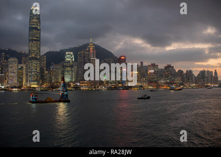 The skyscrapers of Hong Kong's Central District and Sheung Wan dominate the harbour skyline as the sun sets over Sai Wing Pun Stock Photo