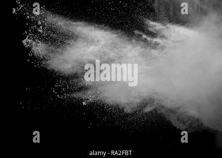 White talcume powder explosion on black background. White dust splashing. Stock Photo